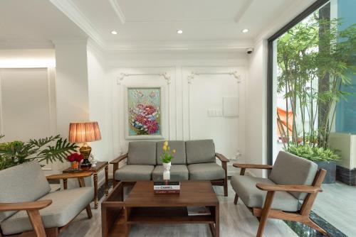 a living room with two chairs and a table at Ngan Ha 2 Apartment Phu My Hung in Ho Chi Minh City