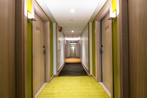 a hallway with green and yellow walls and a long corridor at Clarion Hotel Energy in Stavanger