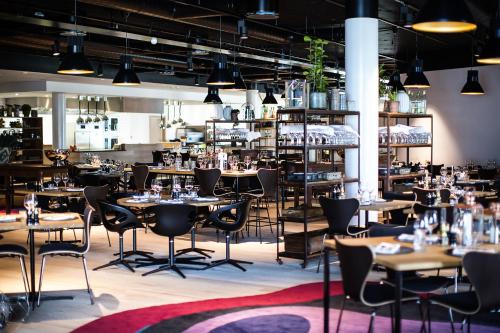 a restaurant with tables and chairs and shelves at Clarion Hotel Energy in Stavanger