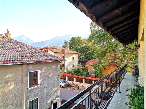 un balcone di una casa con le montagne sullo sfondo di Стаи за гости Дима a Bansko
