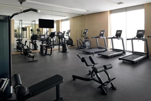 a gym with a bunch of exercise equipment in it at Mövenpick Resort Al Marjan Island in Ras al Khaimah