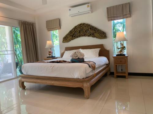 a bedroom with a bed with a stuffed animal on it at Pacotte Villa by G Estate in Rawai Beach