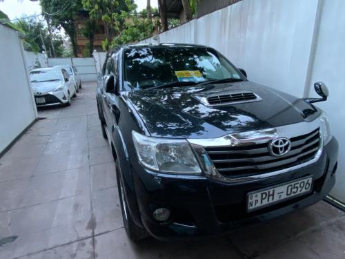 a car parked in a garage next to a wall at Yal's Town Inn in Jaffna