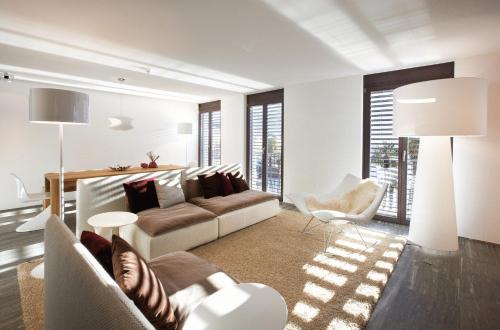 a living room with a couch and a chair at Seven Apartments in Ascona