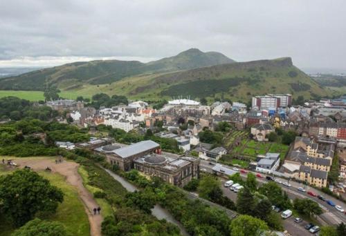 an aerial view of a city with mountains in the background at Ellwyn House in Edinburgh