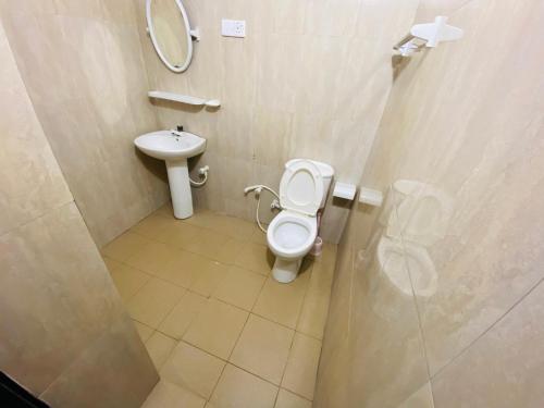 a bathroom with a toilet and a sink at Yal's Town Inn in Jaffna