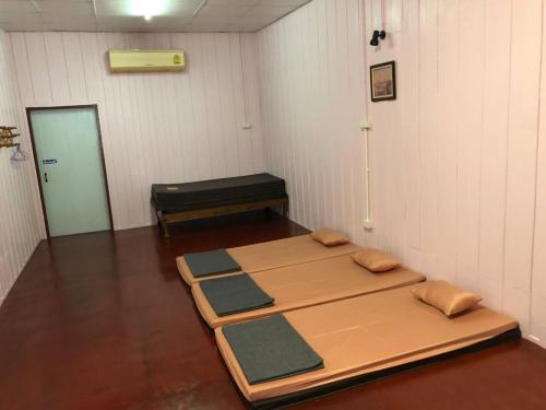 a room with four mats on the floor at Rub Lom Chom Klong Homestay in Chumphon