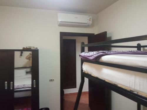 a room with two bunk beds and a closet at شاليه فاخر بالبانوراما بورتوسخنه للعائلات فقط porto sokhna chalets in Ain Sokhna