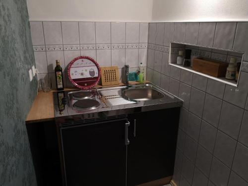 a small kitchen with a sink and a counter top at Apartment am Stadtturm in Freyburg