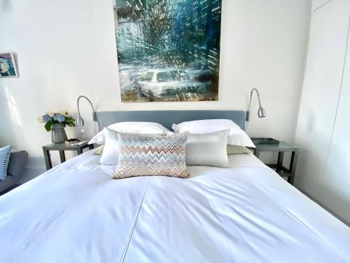 a bed with white sheets and pillows in a bedroom at Camillas Holiday home Copenhagen City Centre in Copenhagen