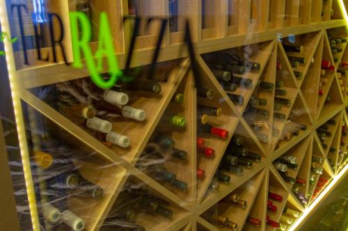 a bunch of wine bottles in a wine rack at La Terrazza Hotel in Mağusa