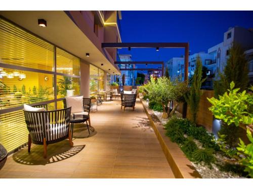 a patio with chairs and tables on a building at La Terrazza Hotel in Mağusa