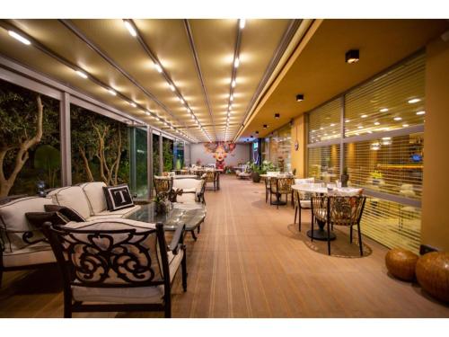a dining room with tables and chairs in a restaurant at La Terrazza Hotel in Mağusa