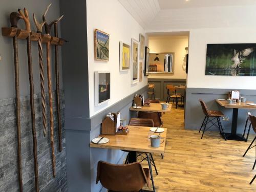 a restaurant with tables and chairs in a room at Ravenscraig Guest House in Aviemore
