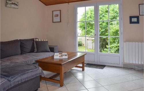 a living room with a couch and a coffee table at Cozy Home In Pleubian With Wifi in Pleubian