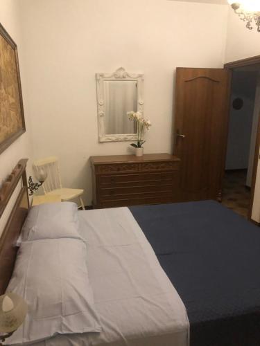 a bedroom with a bed and a dresser and a mirror at Bellorizzonte Colleferro in Colleferro