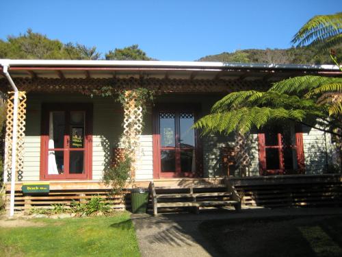 a small house with a bench in front of it at Hopewell Lodge in Kenepuru Sounds