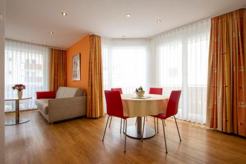 a living room with a table and chairs and a couch at Appartements Feehof in Saas-Fee
