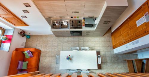 a kitchen with two orange chairs and a stove at Albergo Diffuso Dolomiti in Forni di Sotto