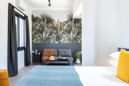 a bedroom with a blue bed and a couch at PAME Wild in Athens