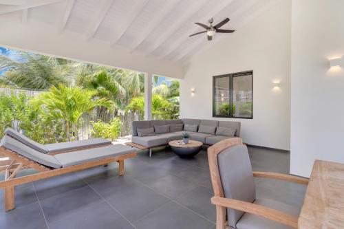 a living room with a couch and chairs at Grand Windsock Bonaire in Kralendijk
