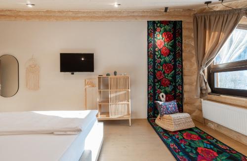 a bedroom with a bed and a wall with a curtain at Casa din Vale in Săcuieu