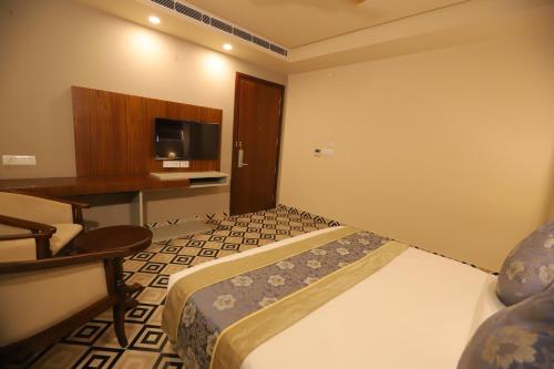 a hotel room with two beds and a television at IP Royal Hotel - New Delhi in New Delhi