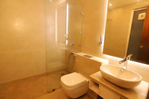 a bathroom with a toilet and a sink and a shower at IP Royal Hotel - New Delhi in New Delhi
