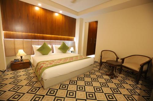 a hotel room with a bed and a chair at IP Royal Hotel - New Delhi in New Delhi
