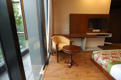 a room with a desk and a chair and a bed at IP Royal Hotel - New Delhi in New Delhi