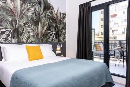a bedroom with a bed and a large window at PAME Wild in Athens