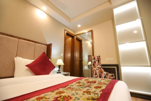 a hotel room with a bed and a chair at IP Royal Hotel - New Delhi in New Delhi