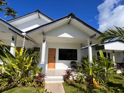 a white house with a welcoming front porch at Pearl of Samui Resort in Lamai