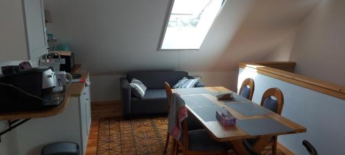 a living room with a table and a couch at Chataa in Szczechy Małe