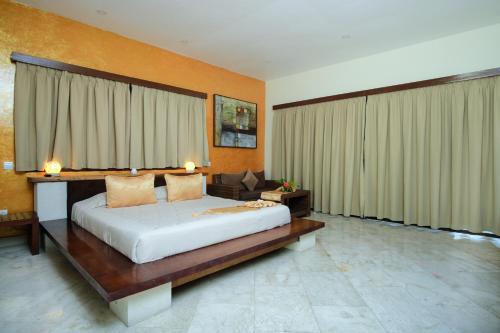 a bedroom with a large bed and a couch at Pearl of Trawangan in Gili Trawangan