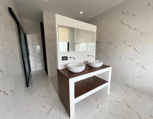a bathroom with two sinks and a mirror at Pearl of Samui Resort in Lamai