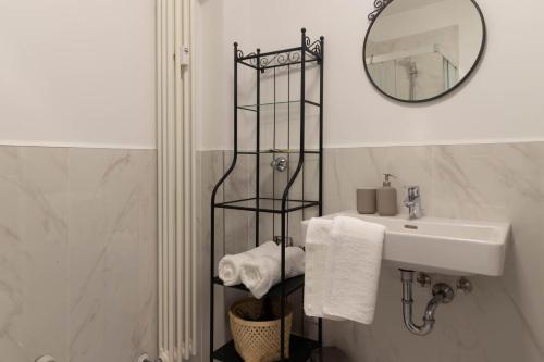a bathroom with a sink and a mirror at Apartments Iris in Merano