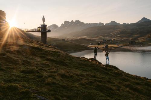 two people standing on a hill near a body of water at Frutt Mountain Resort in Frutt