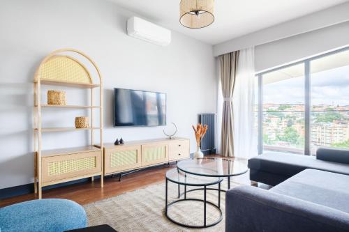 a living room with a couch and a tv at Benesta Residence by NewInn in Istanbul