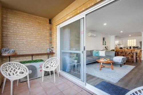 a living room with a large sliding glass door at Nautica Residences Hillarys in Perth