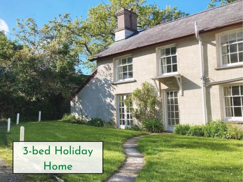 a house with a sign that reads bed holiday home at Plas Dolau Country Estate in Aberystwyth