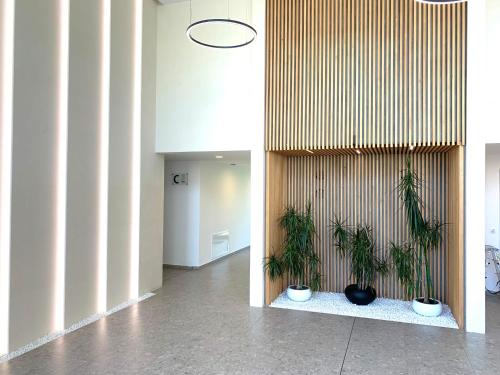 a hallway with two potted plants on a wall at ELINOR Apartments - C29 in St. St. Constantine and Helena