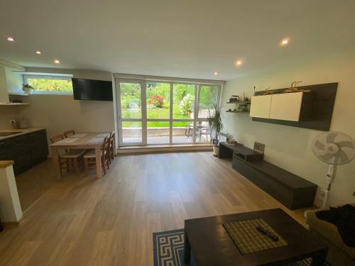 a living room with a kitchen and a dining room at Apartment Pusynas in Nida