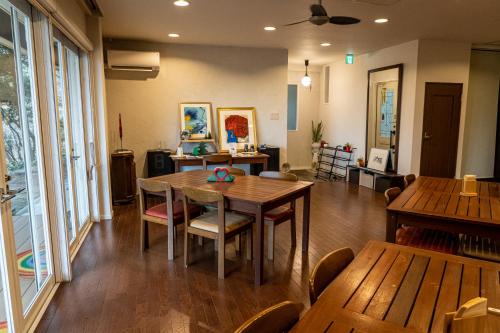 a dining room with a table and chairs at Rokko Outdoor Station FOTON in Kobe
