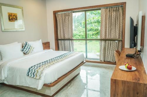 Postel nebo postele na pokoji v ubytování Nest Beacon Resort Daman