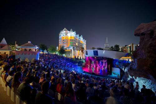 a crowd of people watching a concert at night at Kamelya Aishen Club & Aqua Ultra All Inclusive Kids Concept in Side