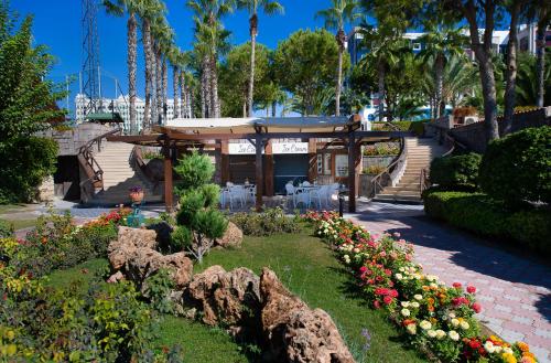 a kiosk with flowers in a park with palm trees at Kamelya Aishen Club & Aqua Ultra All Inclusive Kids Concept in Side
