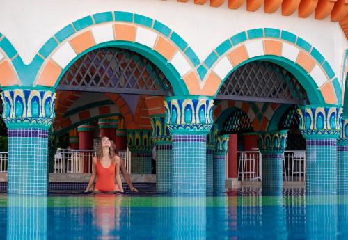 a woman sitting in the water in a swimming pool at Kamelya Aishen Club & Aqua Ultra All Inclusive Kids Concept in Side