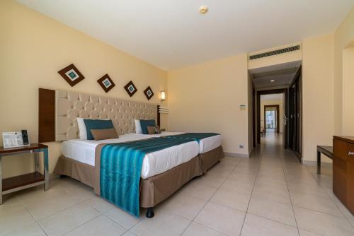 a large bedroom with a large bed and a hallway at Kamelya Aishen Club & Aqua Ultra All Inclusive Kids Concept in Side
