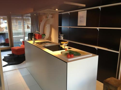 a kitchen with a counter with a sink and a counter sidx sidx sidx at Kar Design Appartements in Lech am Arlberg